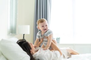 What is postnatal massage: A mother playing with his baby
