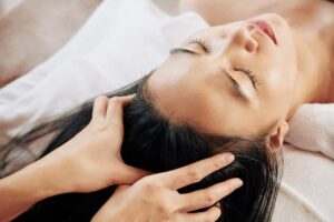 postnatal; hand giving a head massage