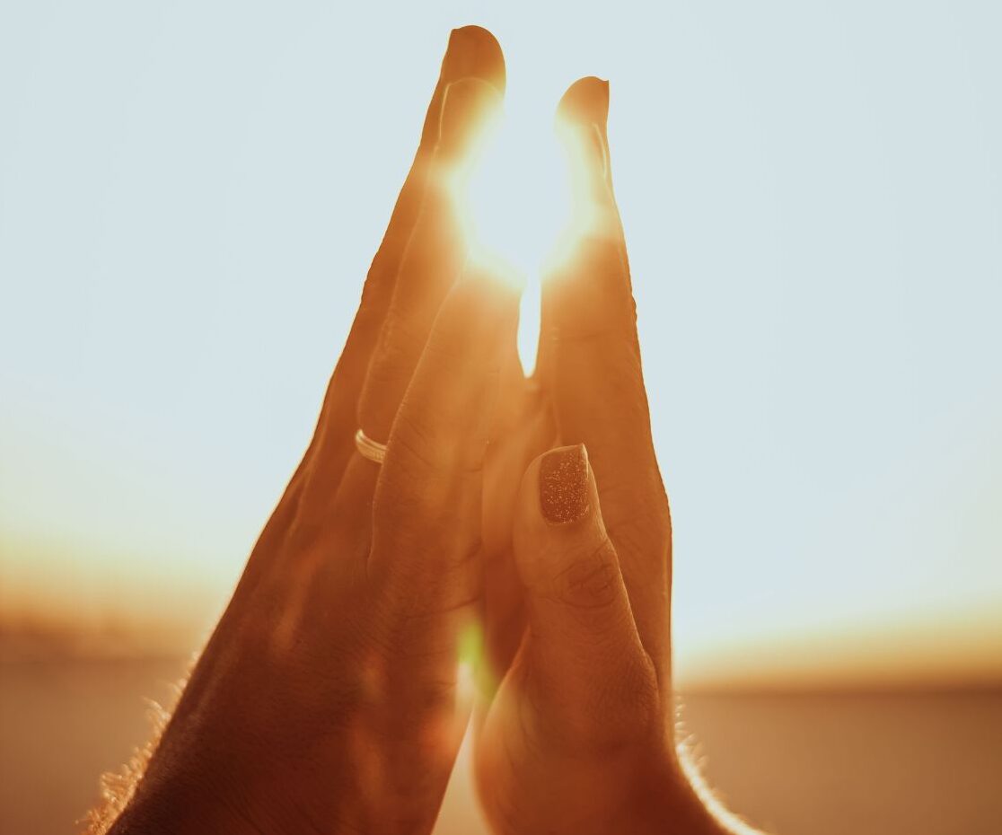 A serene holistic therapy session where a therapist gently massages a client in a softly lit room with natural elements like plants, essential oils, and healing stones. A diffuser emits a relaxing mist in the background, creating a warm and soothing atmosphere that symbolizes the healing power of touch.