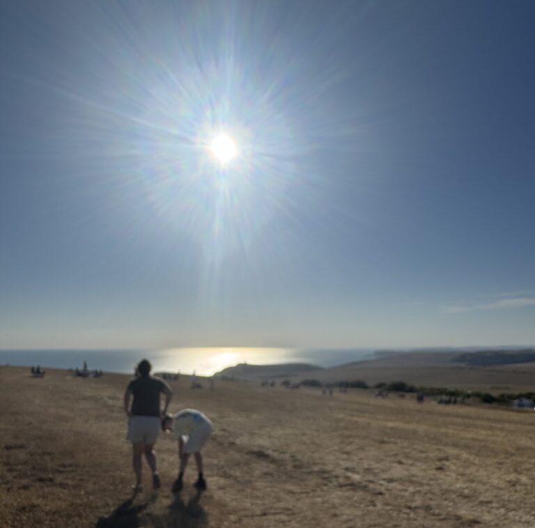 Sunlight over the South Downs and sea, a quiet moment in nature reflecting pause, awareness and returning to balance.