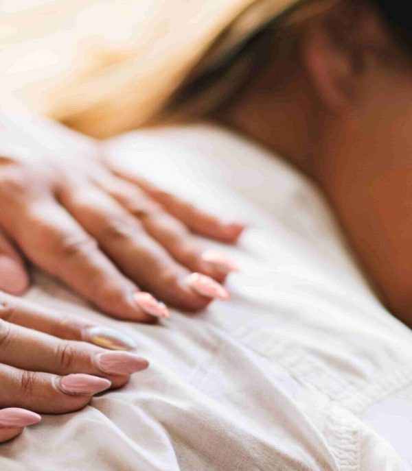 Hands on back of a woman for Reiki Treatment